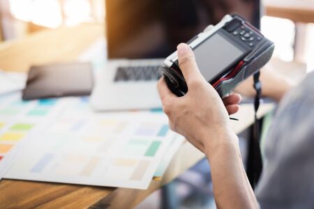 Photography Ideas Creative Occupation Design Studio Concept, Female photographer sitting on the desk with laptop.の写真素材
