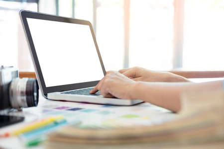Photography Ideas Creative Occupation Design Studio Concept, Female photographer sitting on the desk with laptop.の写真素材