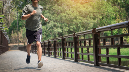 Running man. Male runner at sprinting speed training for marathon outdoors.の写真素材