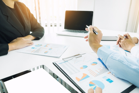 Team work process. young business managers crew working with new startup project. laptop on wood table, typing keyboard, texting message, analyze graph plans.の写真素材