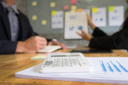 business man financial inspector and secretary making report, calculating or checking balance. Internal Revenue Service inspector checking document. Audit concept at working with plan on office desk and modern digital tabletの写真素材