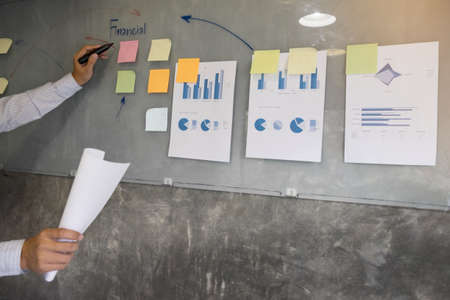 Business man speaker giving a talk finance profit graph presentation meeting audience in the conference modern office at board brainstorming meeting working concept.の写真素材