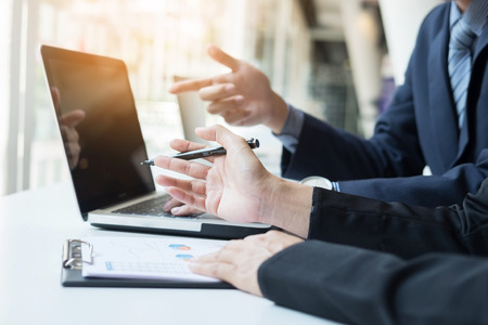 Team work process. young business managers crew working with new startup project. tablet on wood table, typing keyboard, texting message, analyse graph plans.の写真素材