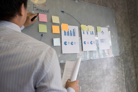 Business man speaker giving a talk finance profit graph presentation meeting audience in the conference modern office at board brainstorming meeting working concept.の写真素材