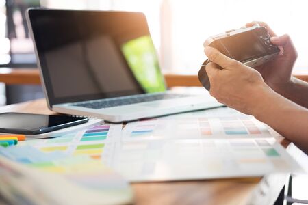 Photography Ideas Creative Occupation Design Studio Concept, Female photographer sitting on the desk with laptop.の写真素材