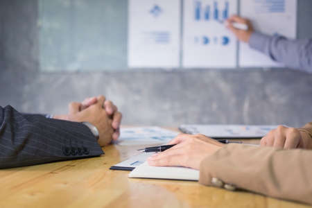 Business man speaker giving a talk finance profit graph presentation meeting audience in the conference modern office at  meeting workingの写真素材