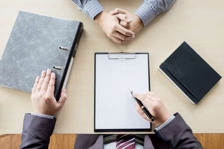 top view of Businessman conducting an interview with businessman in an office.の写真素材