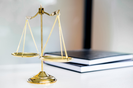 Law scales or golden weight and legals books on table. Symbol of justice.の写真素材