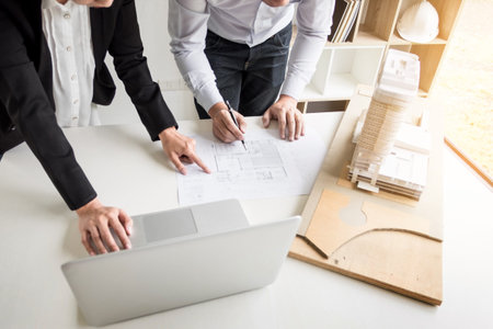 Person's engineer Hand Drawing Plan On Blue Print with architect equipment.
