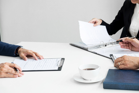 Businessman conducting an interview with businessman in an office.の写真素材