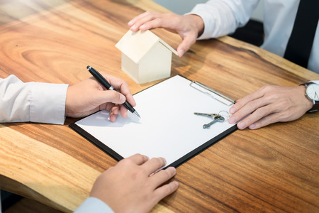 customer signing contract, agreed terms and approved application and analyzing valuation home loan, meeting with bank worker or real estate agentの写真素材