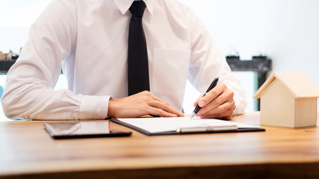 customer signing contract, agreed terms and approved application and analyzing valuation home loan, meeting with bank worker or real estate agentの写真素材