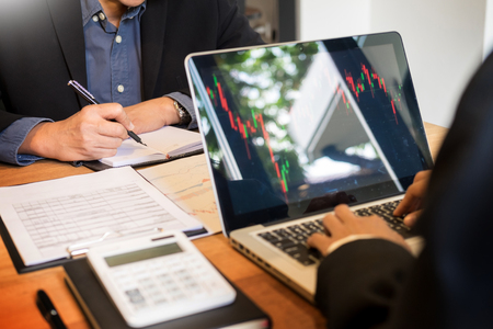 Finance trade manager showing reports screen analysis finance currency data on stock trade graph on business currency market.の写真素材