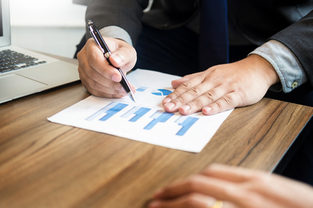 Business man analysed report of profit finance data graph document in his officeの写真素材