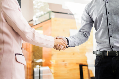 Two confident business man shaking hands during a meeting in the office, success, dealing, greeting and partner concept.の写真素材