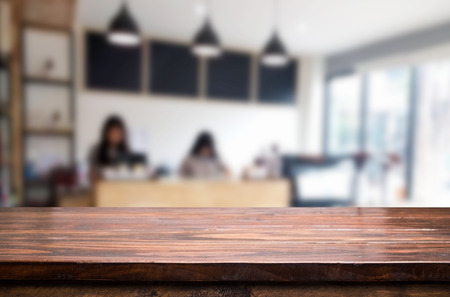 Selected focus empty brown wooden table and Coffee shop blur background with bokeh image. for your photomontage or product display.の写真素材