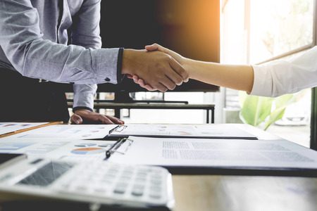 Two confident business man shaking hands during a meeting in the office, success, dealing, greeting and partner concept.の写真素材