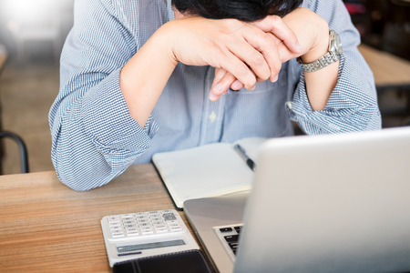 stressed businessman Feeling sick and tired while sitting at his working place in office, deadline conceptの写真素材
