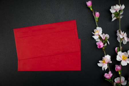 Flat lay holiday of Chinese new year red packet and of accessories blossom on top and Lunar festival concept background, Other language means wealthy or rich and happinessの写真素材