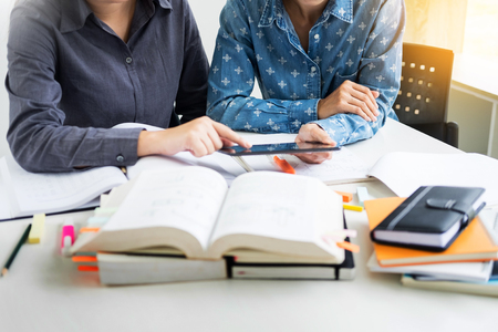 Young students campus helps friend catching up and learning tutoring. People, learning, education and school concept.の写真素材
