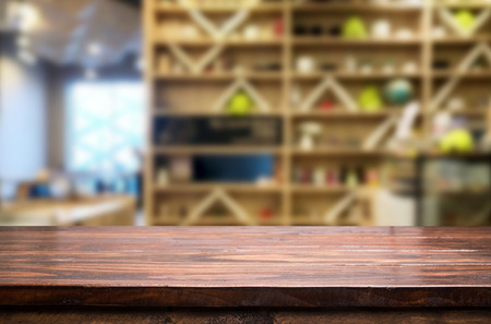 Selected focus empty brown wooden table and Coffee shop or restaurant blur background with bokeh image. for your photomontage or product displayの写真素材