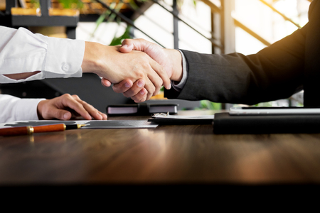 Two confident business man shaking hands during a meeting in the office, success, dealing, greeting and partner concept.の写真素材