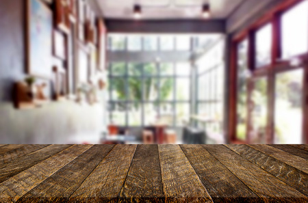 Selected focus empty brown wooden table and Coffee shop or restaurant blur background with bokeh image. for your photomontage or product displayの写真素材