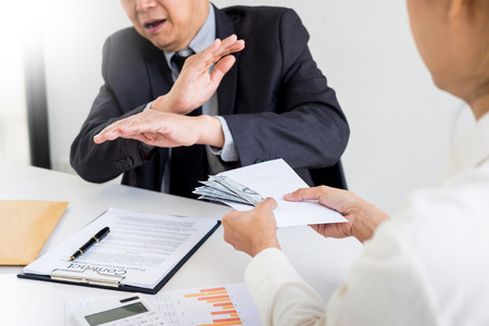Businessman refusing or rejecting money in the envelope - anti bribery and corruption conceptsの写真素材