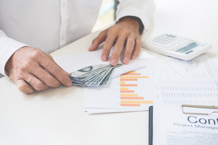 business man counting money at the table  accounting concept.の写真素材