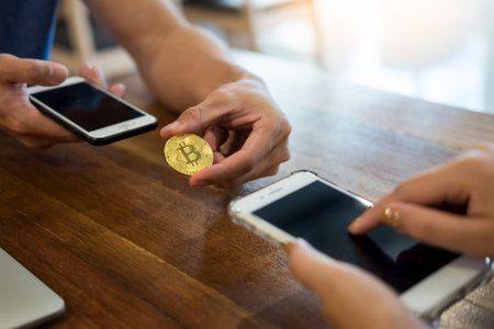 hand exchange golden metal Bitcoin crypto currency investment- symbolic block chain financial...