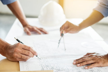 Close-up Of Person's engineer Hand Drawing Plan On Blue Print with architect equipment, Architects...