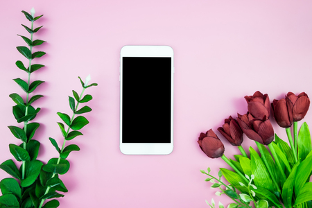 Flat lay mock-up photo with Creative header design mockup set of workspace desk with blank of free copy space screen smartphone Tropical Leave on Pink Pastel color background, Technology concept minimal styleの写真素材