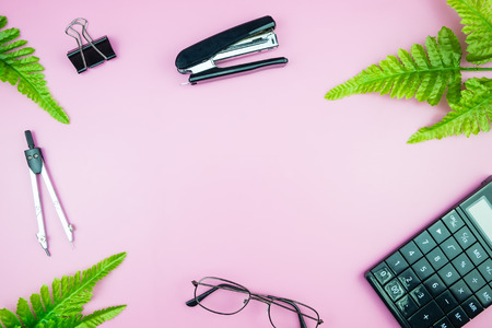 Office table desk with business computer, green leaves palm, clipboard feminine tabletop. flat lay image of workplace and copy spaceの写真素材