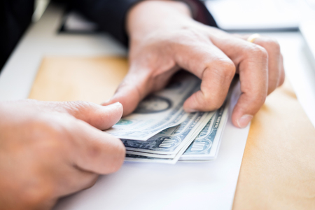 business man counting money at the table, accounting concept.の写真素材