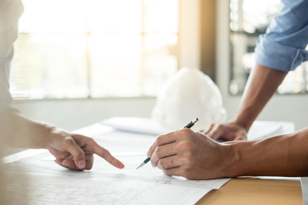 Close-up Of Person's engineer Hand Drawing Plan On Blue Print with architect equipment, Architects discussing at the table, team work and work flow construction concept.の写真素材