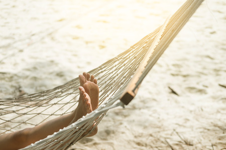 Woman relaxing in the hammock at the beachの写真素材