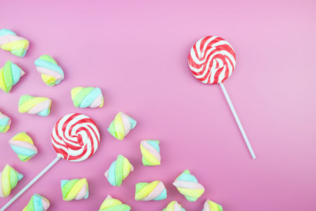 Flat lay top view tasty appetizing concept, minimal Sweet Treat Swirl Candy Lollipop marshmallow...