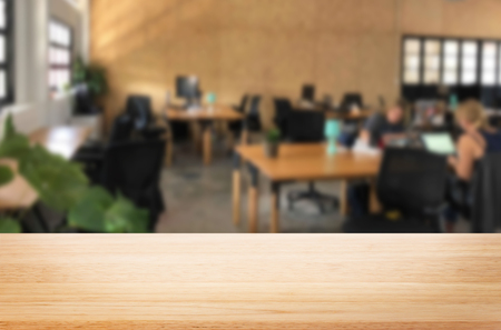 Selected focus empty brown wooden table in office with big windows of the Background with bokeh image. for your photomontage or product display.の写真素材