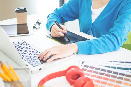 interior design or graphic designer renovation and technology concept - woman working with colour samples for selection. at workplace choosing colour swatches, closeup. Creative peopleの写真素材