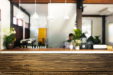 Selected focus empty brown wooden table and Coffee shop or restaurant blur background with bokeh image. for your photomontage or product display.の写真素材