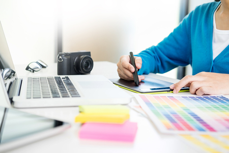 interior design or graphic designer renovation and technology concept - woman working with colour samples for selection. at workplace choosing colour swatches, closeup. Creative peopleの写真素材