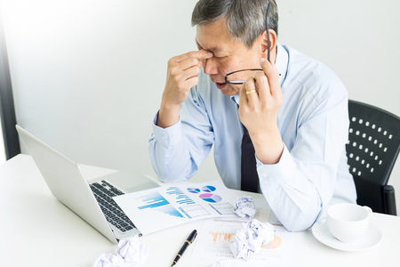 Depressed failure and tired businessman late sad and solving problem in office. in meeting room. stressed and worried at work crisis concept.の写真素材