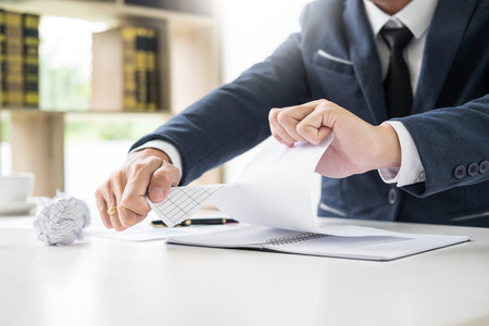 Depressed failure and tired businessman late sad and solving problem in office. in meeting room. stressed and worried at work crisis concept.の写真素材