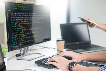 Asian team Outsource Developer Looking Screen Programming Code Working with Laptop Computer Softwareの写真素材