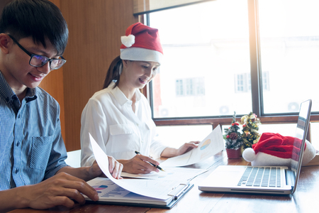 successful Business people wearing Santa hat  celebrating 2019 New Year Christmas presents at office party, having great timeの写真素材