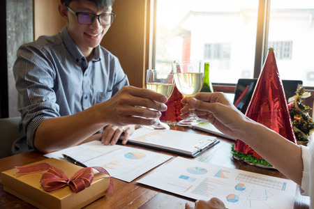 successful Business people wearing Santa hat  celebrating 2019 New Year Christmas presents at office party, having great timeの写真素材