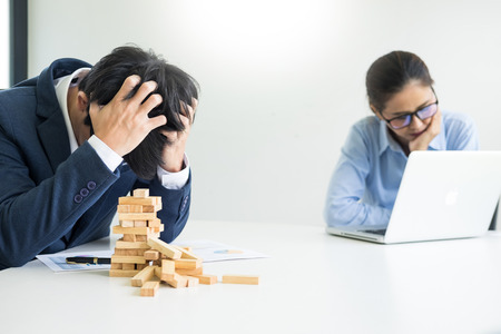 Depressed failure and tired businessman late sad and solving problem in office. in meeting room. stressed and worried at work crisis concept.の写真素材