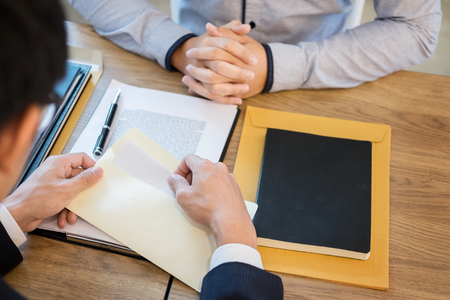 businessman hand sending a resignation letter to executive boss dismissed worker quit out from company, Change job, unemployment, resign concept.の写真素材