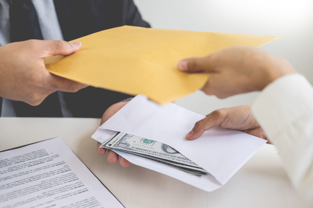 Corrupted businessman, or politician bribe in the form of hundred dollar bills. among high-ranking officials.の写真素材