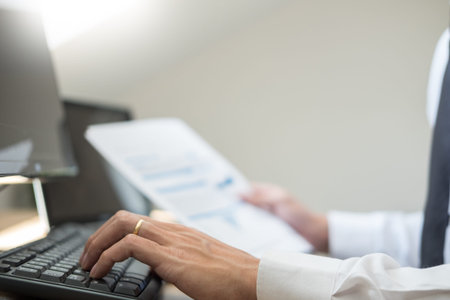 Stock exchange trader Analyzing Graphs chart or data On Multiple Screens in office